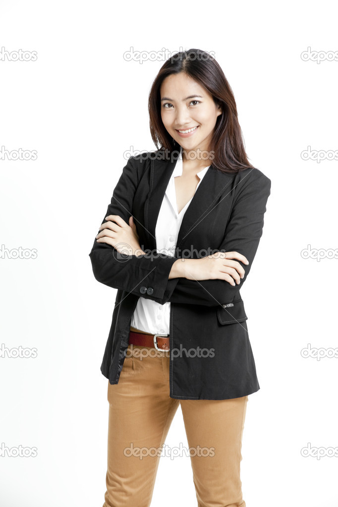 Portrait of a happy young business woman standing with folded hand against white background