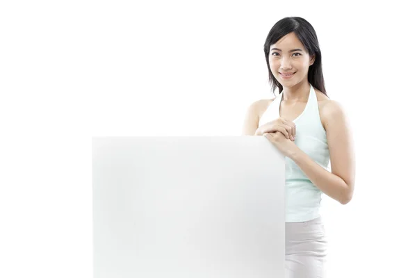 Femme décontractée debout derrière un tableau blanc sur fond blanc (concept vert ) — Photo