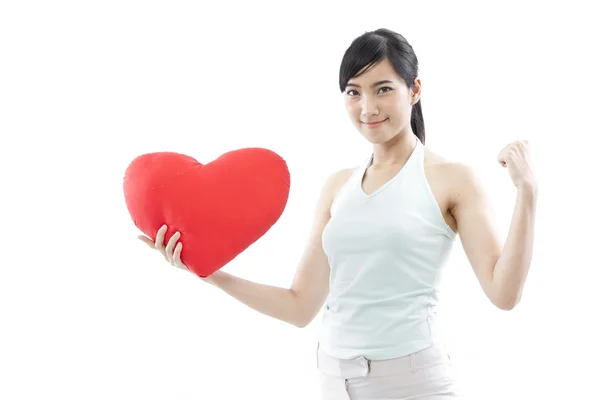 Portret van aantrekkelijke Aziatische lachende vrouw en hand met rood hart geïsoleerd op witte studio shot — Stockfoto
