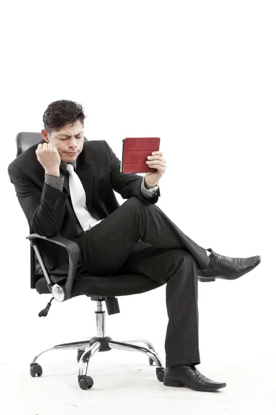 Portrait of a businessman sitting with digital tablet — Stock Photo, Image