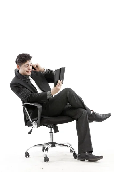 Portrait of a businessman sitting with digital tablet — Stock Photo, Image