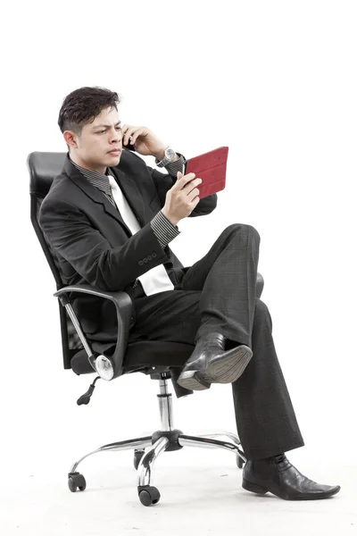 Portrait of a businessman sitting with digital tablet — Stock Photo, Image