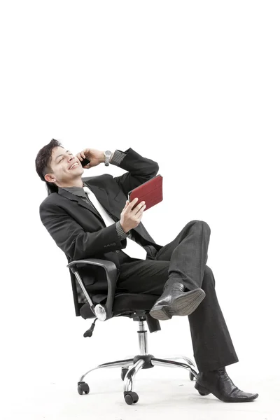 Portrait of a businessman sitting with digital tablet — Stock Photo, Image