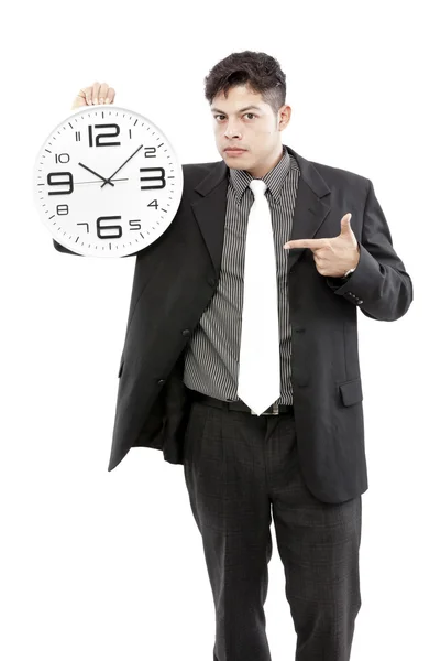 Portrait of a businessman holding a clock against white background — Stock Photo, Image