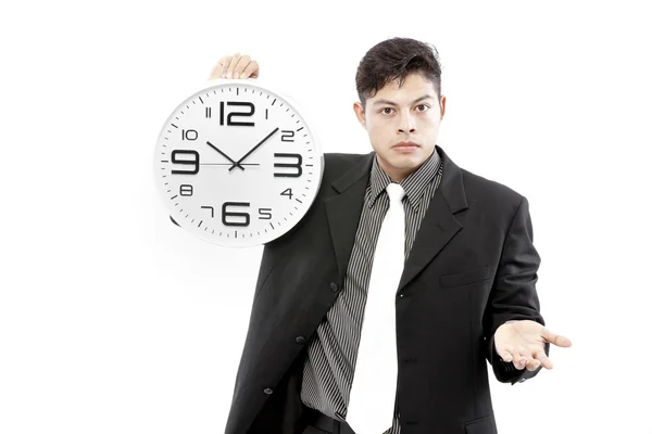 Portrait of a businessman holding a clock against white background — Stock Photo, Image