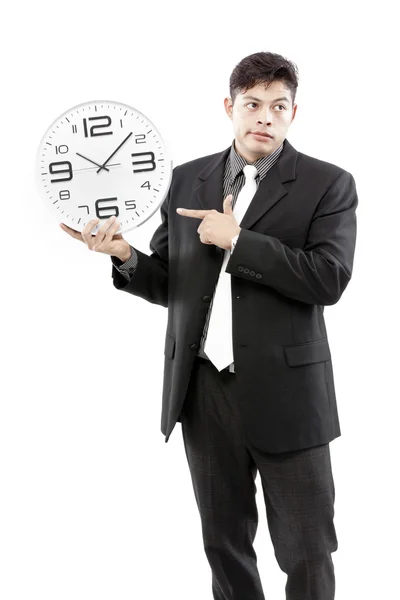 Portrait of a businessman holding a clock against white background — Stock Photo, Image