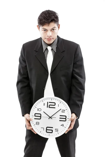Portrét podnikatel drží hodiny proti Bílému pozadí — Stock fotografie