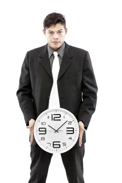 Retrato de un hombre de negocios sosteniendo un reloj sobre fondo blanco — Foto de Stock