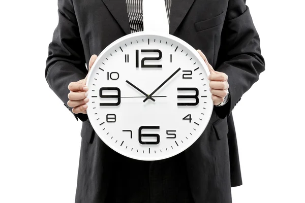 Porträtt av en affärsman som håller en klocka mot vit bakgrund — Stockfoto