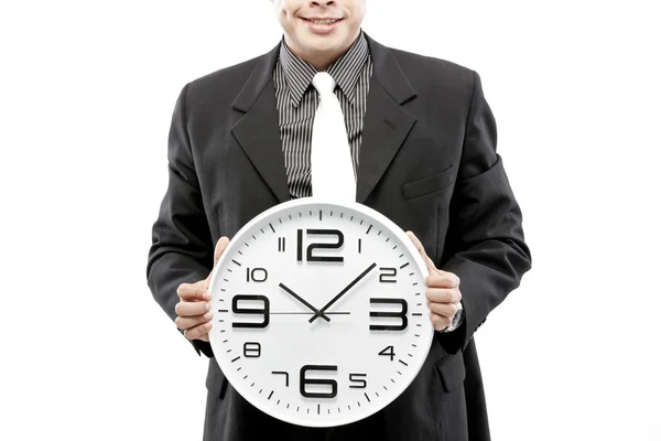Retrato de un hombre de negocios sosteniendo un reloj sobre fondo blanco —  Fotos de Stock