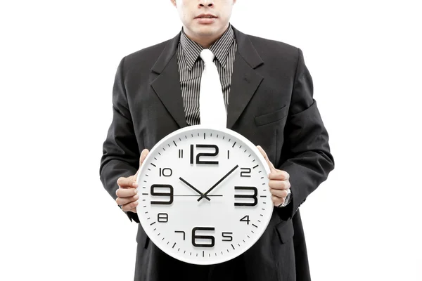 Retrato de un hombre de negocios sosteniendo un reloj sobre fondo blanco — Foto de Stock