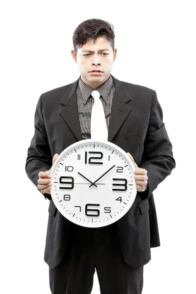 Concepto de tiempo, hombre de negocios sosteniendo gran reloj y dar la expresión en su cara — Foto de Stock