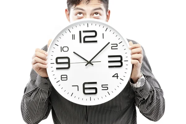 Concepto de tiempo, hombre de negocios sosteniendo gran reloj y dar la expresión en su cara — Foto de Stock