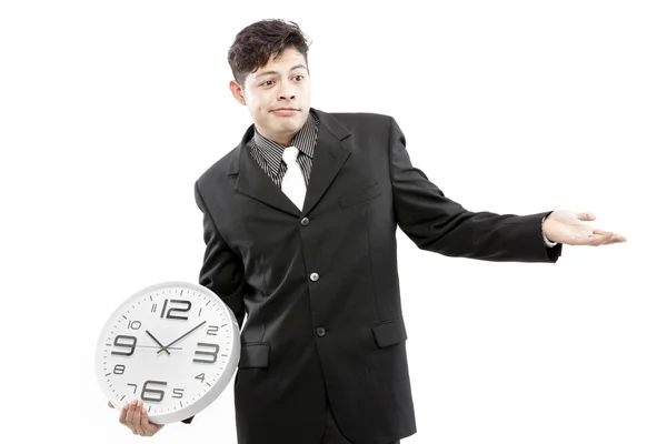 Έννοια του χρόνου, επιχειρηματίας που κατέχουν μεγάλο ρολόι και να δώσει την έκφραση στο πρόσωπό του — Φωτογραφία Αρχείου