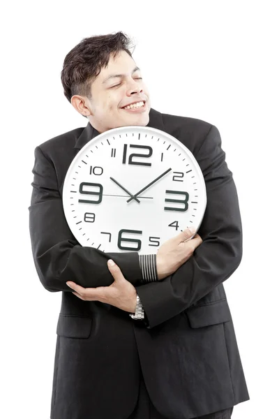Сохранение времени, крупный план молодого бизнесмена с аналоговыми часами, изолированными на белом фоне — стоковое фото