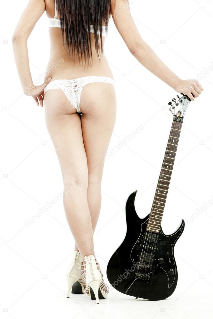 Sexy picture of standing back woman covering her bare butt with guitar over white background