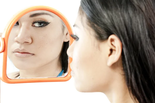 A closeup mirror reflection of a woman's face, selective focus — Stock Photo, Image