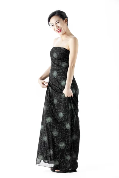 Beautiful young woman wearing a black evening dress — Stock Photo, Image