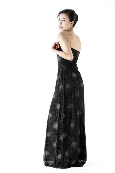 Beautiful young woman wearing a black evening dress — Stock Photo, Image