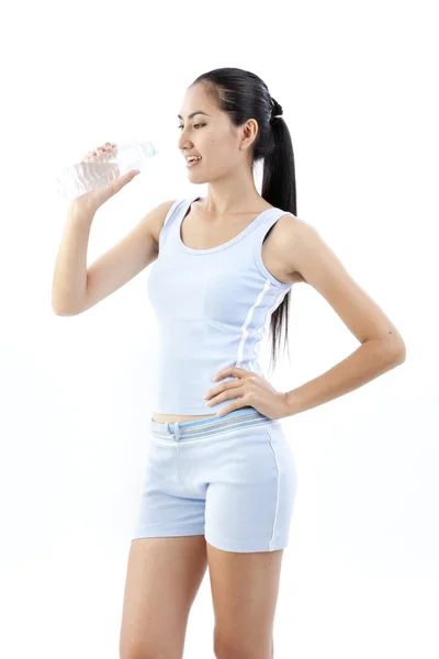 Sporty woman drinking water, isolated against white background — Stock Photo, Image