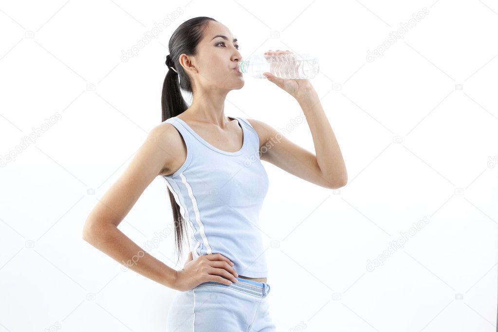 Sporty woman drinking water, isolated against white background