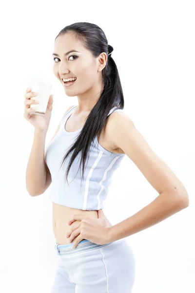 Une femme qui boit du lait. Joyeux et souriant belle jeune femme profitant d'un lait en verre . — Photo