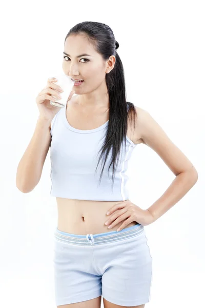 Mujer bebiendo leche. Feliz y sonriente hermosa joven disfrutando de una leche de vidrio . — Foto de Stock