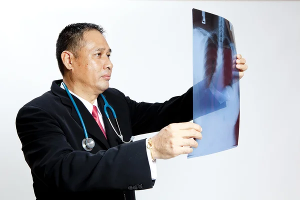 Senior doctor checking xray results — Stock Photo, Image