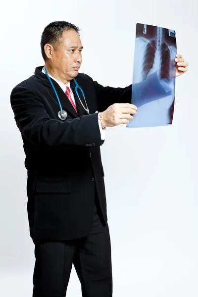 Senior doctor checking xray results — Stock Photo, Image