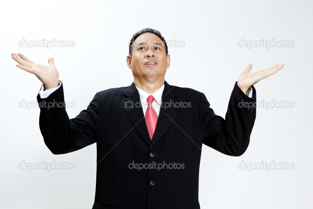 A man holding up his hands showing he has no money, isolated against a white background
