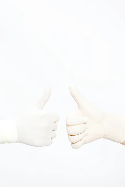 Hand with a latex glove expressing positivity — Stock Photo, Image