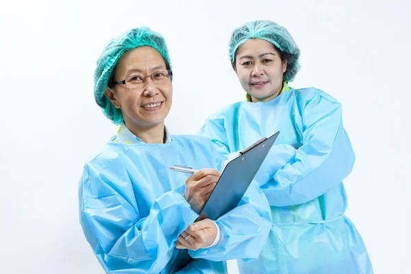 Smiling female medical doctor and nurse with stethoscope and clipboard — Stock Photo, Image