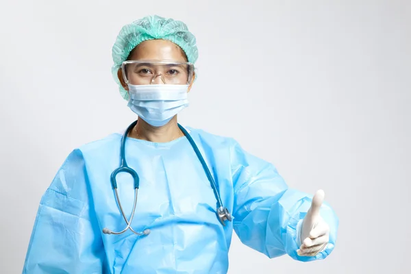 Smiling young female medical doctor with stethoscope and mask — Stock Photo, Image