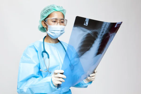 Young and nice doctor watching a patient x-ray in hospital — Stock Photo, Image