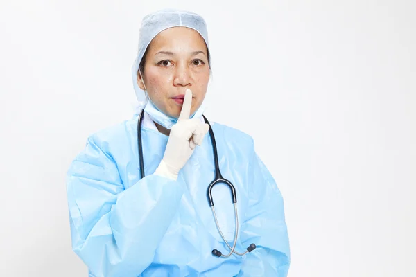 Nahaufnahme Porträt einer Ärztin, die Schweigezeichen auf weißem Hintergrund macht — Stockfoto