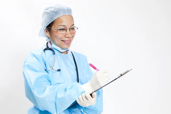 Female doctor writing on medical chart - copyspace — Stock Photo, Image