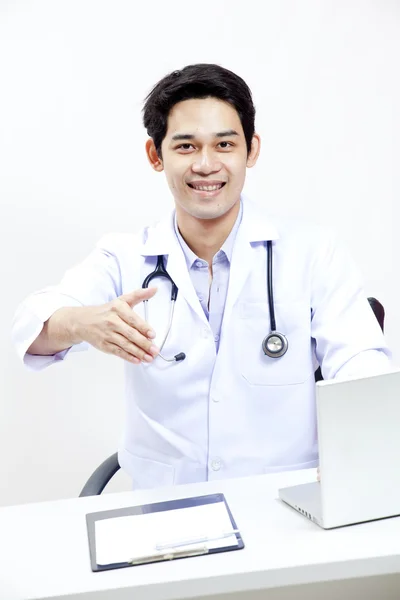 Portrait of a confident mature doctor sitting at his office desk — Stock Photo, Image