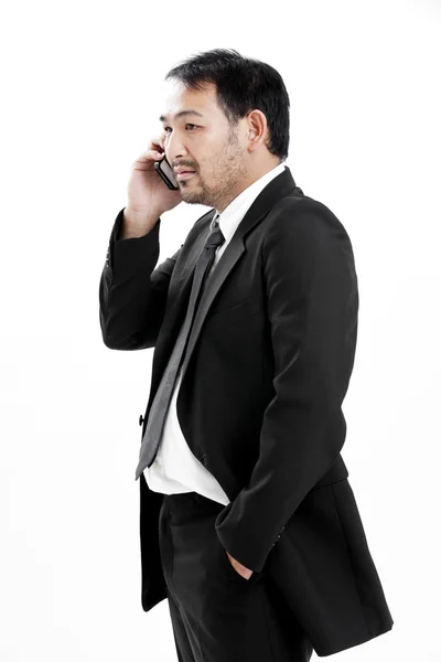 Mature business man talking on the phone over white background — Stock Photo, Image