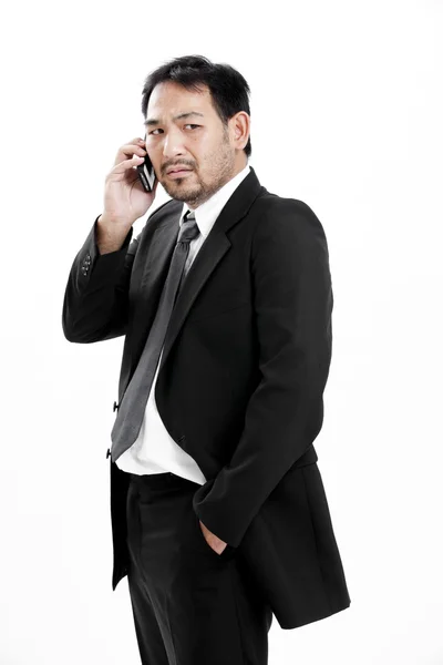 Volwassen zakenman praten over de telefoon op witte achtergrond — Stockfoto
