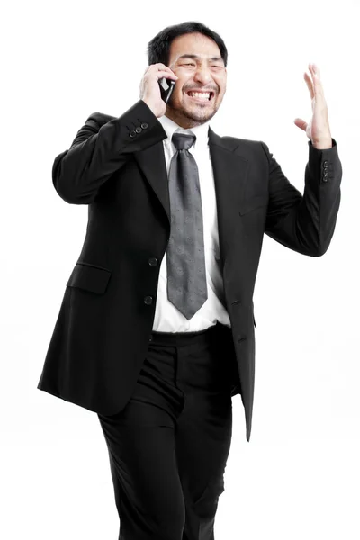 Porträt eines aufgeregten jungen Mannes, der den Erfolg mit erhobener Hand vor weißem Hintergrund feiert — Stockfoto