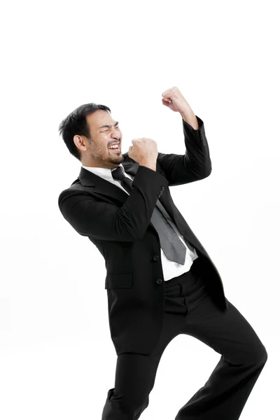 Porträt eines aufgeregten jungen Mannes, der den Erfolg mit erhobener Hand vor weißem Hintergrund feiert — Stockfoto