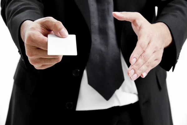 Business man handing a blank business card over white background — Stock Photo, Image