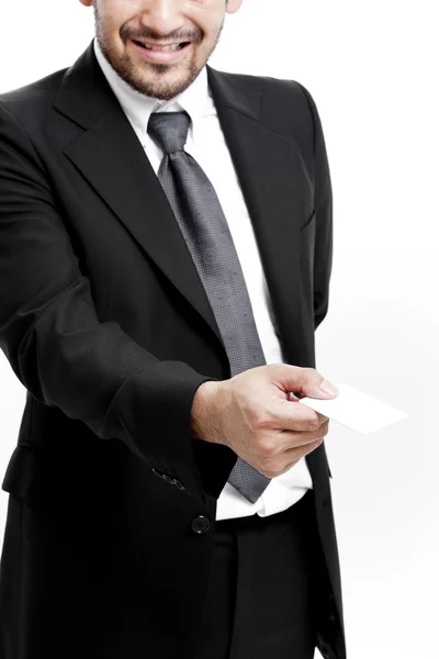 Business man handing a blank business card over white background — Stock Photo, Image