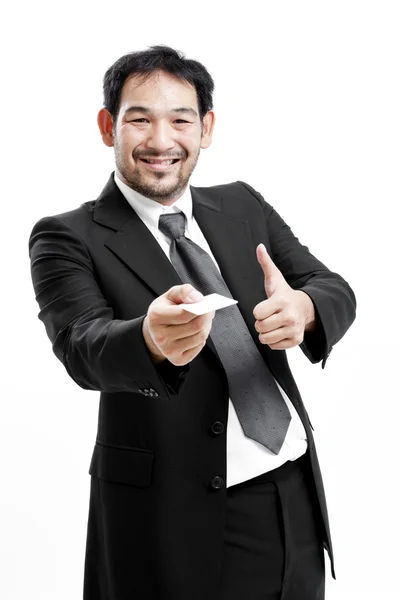 Business man handing a blank business card over white background — Stock Photo, Image