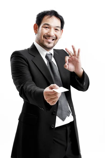 Business man handing a blank business card over white background — Stock Photo, Image