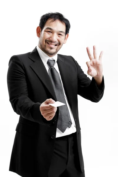 Business man handing a blank business card over white background — Stock Photo, Image