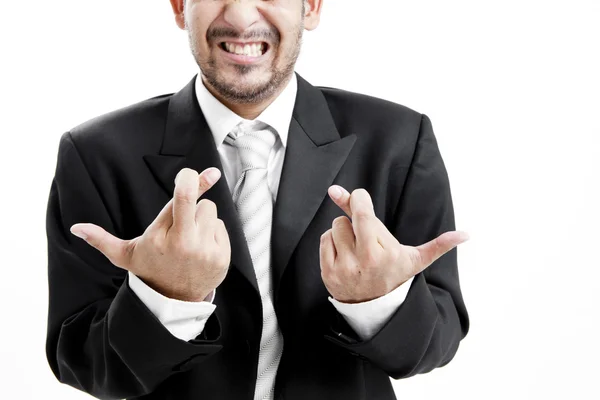 Superstitieux homme d'affaires asiatique avec les doigts croisés sur fond blanc — Photo