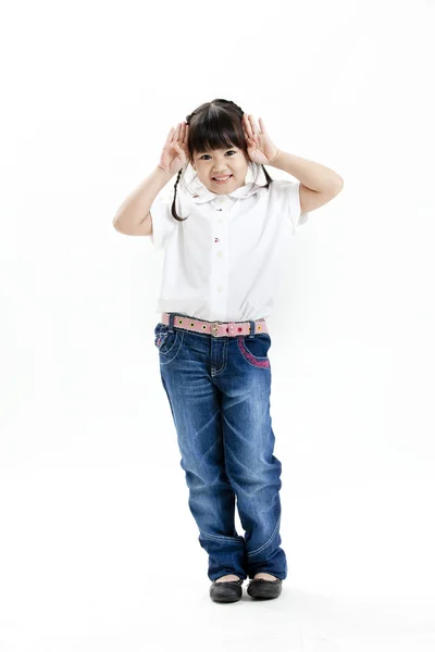 Little girl portrait with white shirt and blue jeans having fun on the white background — Stock Photo, Image