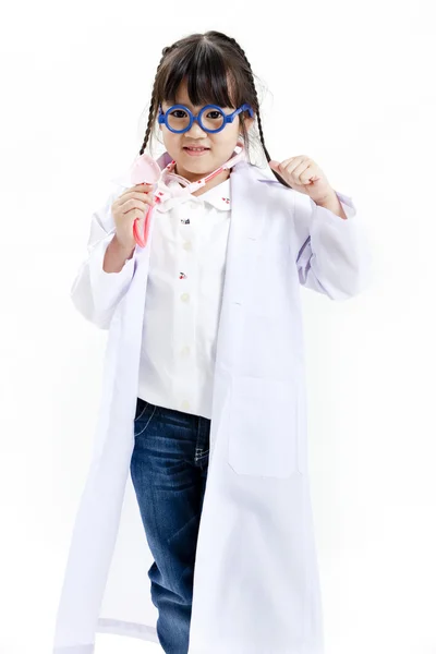 A young asian girl having fun playing dress up as a doctor — Stock Photo, Image