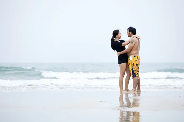 Happy couple walking on beach — Stock Photo, Image